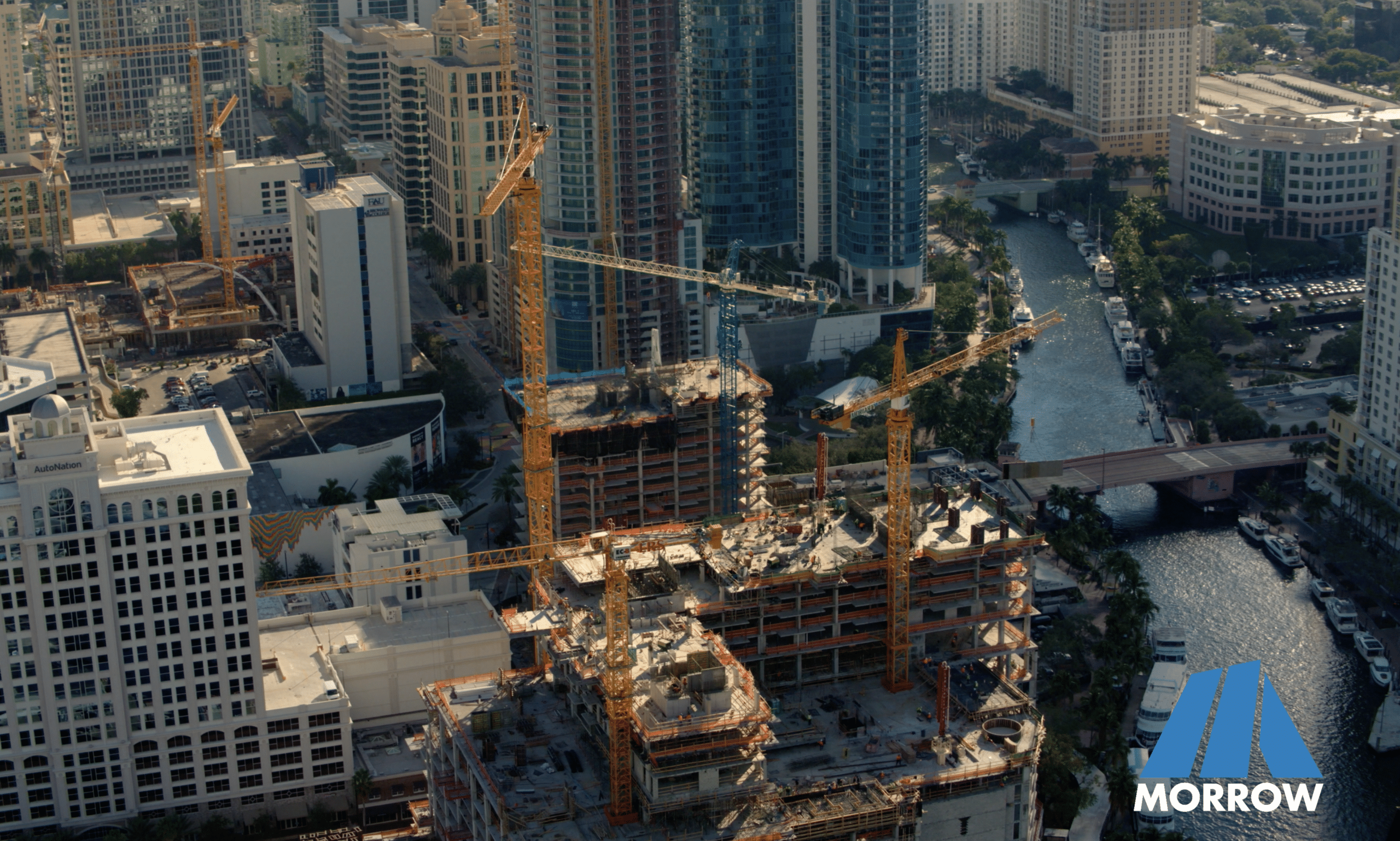Downtown construction site with cranes and buildings.